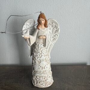 Beautiful intricate angel in white dress holding dove Christmas ornament